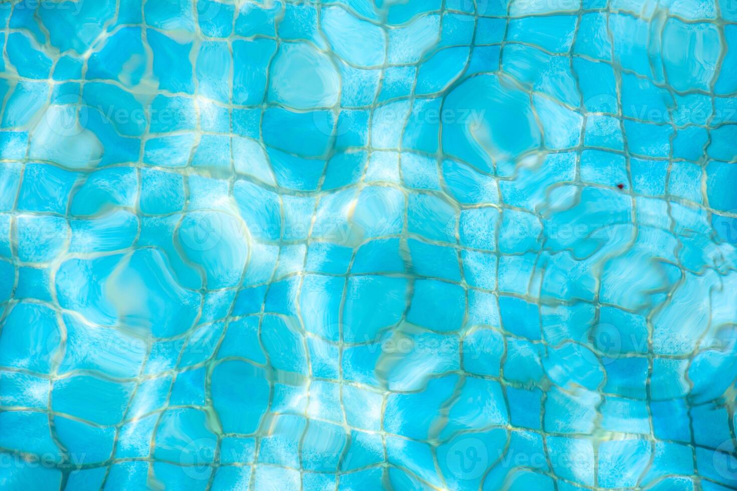 Blue water surface viewed from above in outdoor swimming pool, sun reflection. Abstract surface water background, summer holidays concept photo