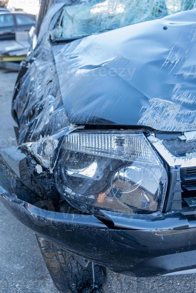 front end of a car damaged after a collision in a traffic accident photo