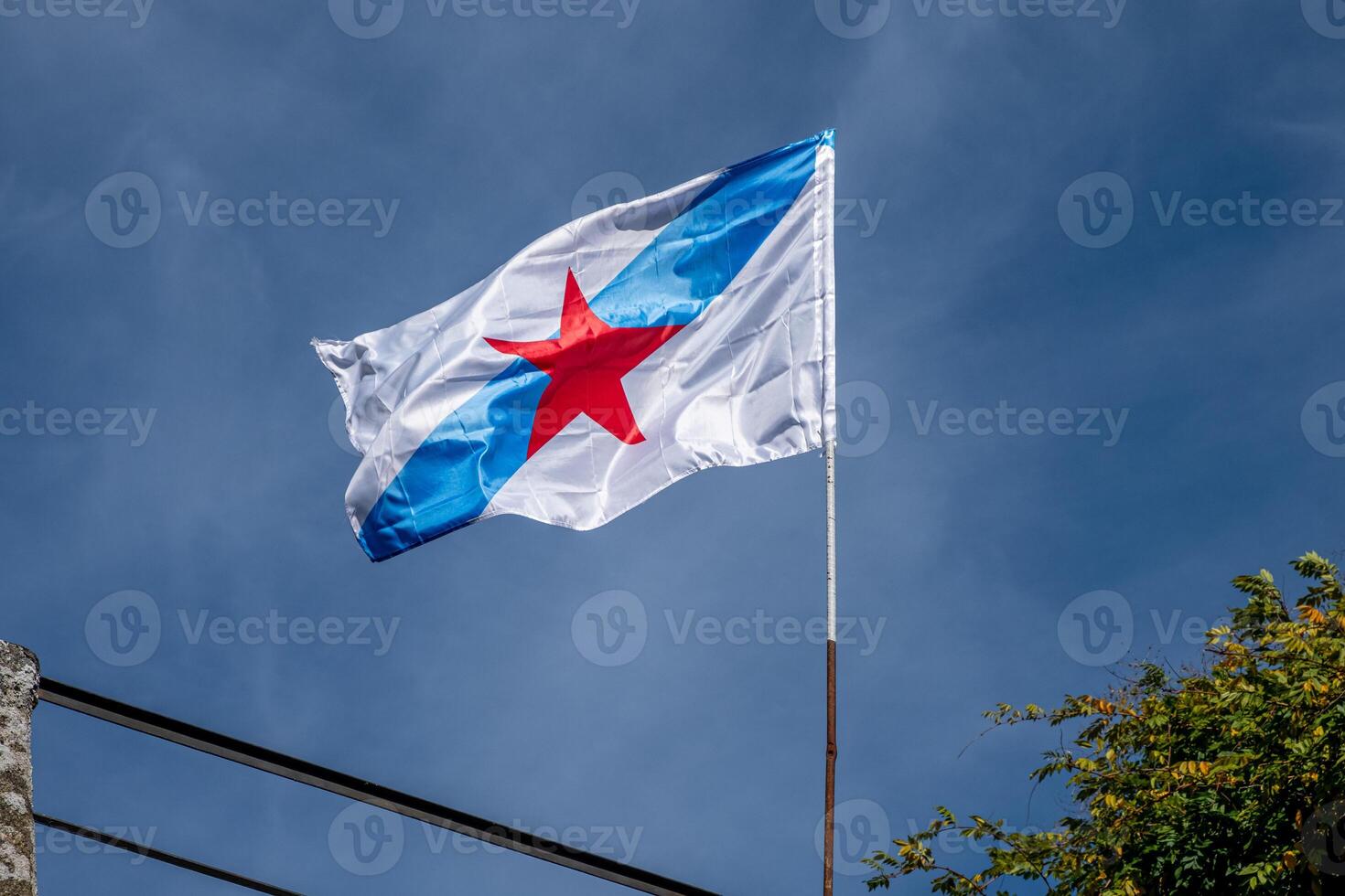 Flag of Galicia with a red star used by those who defend independence, called Estreleira photo