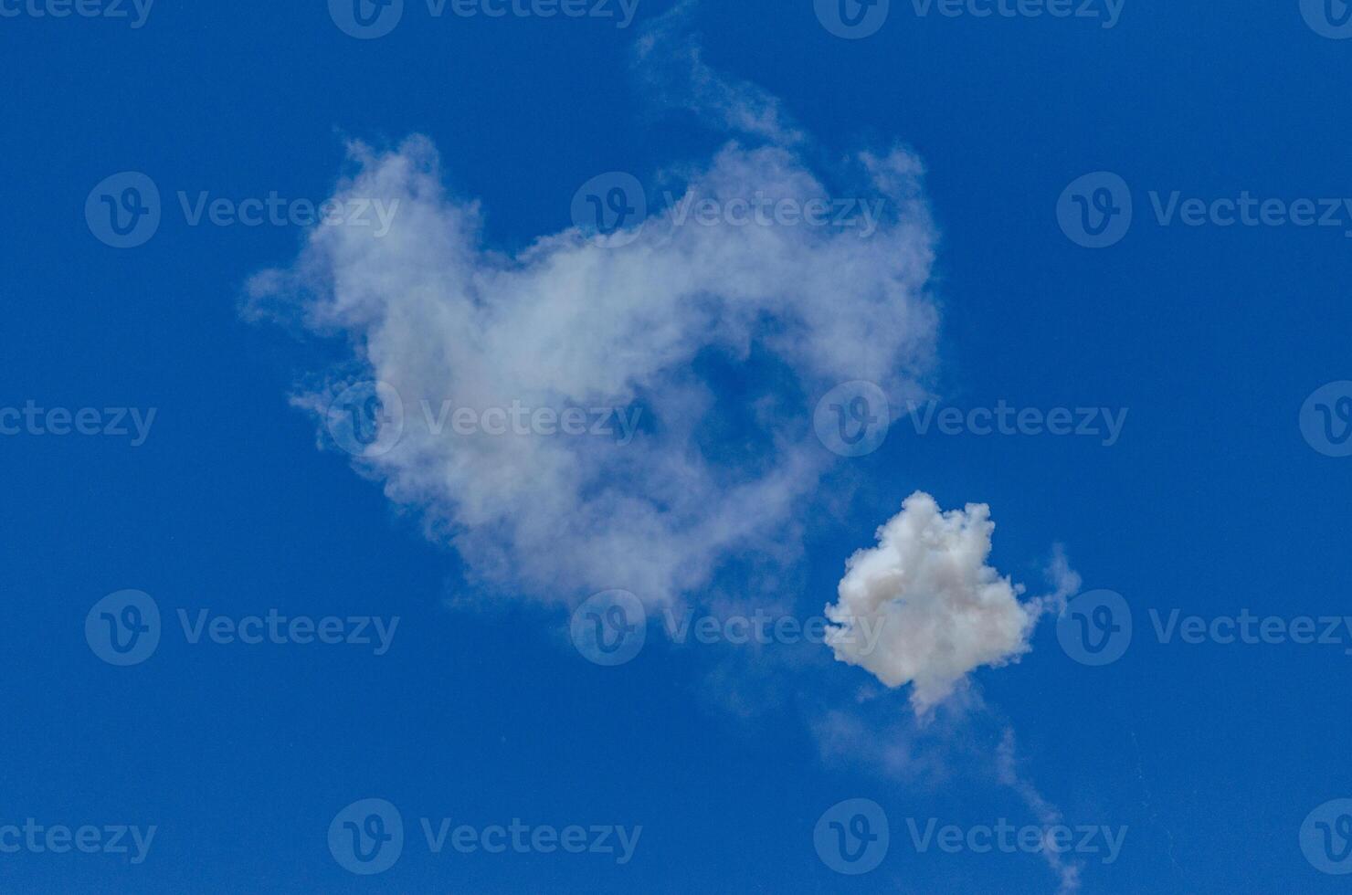 clouds of smoke from pyrotechnics, fireworks in a blue sky photo