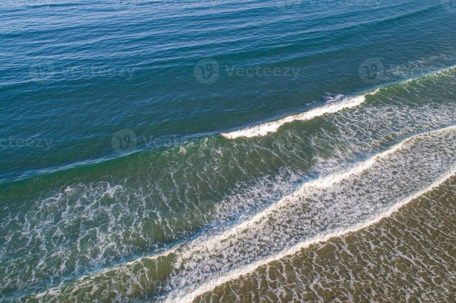 aerial view of the shore of a beach at dawn photo