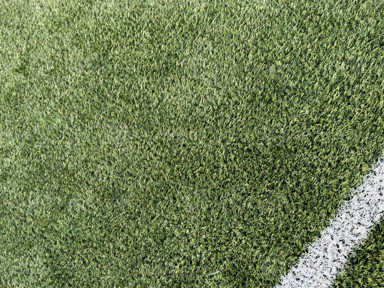 green field in soccer stadium. ready for game in the midfield photo