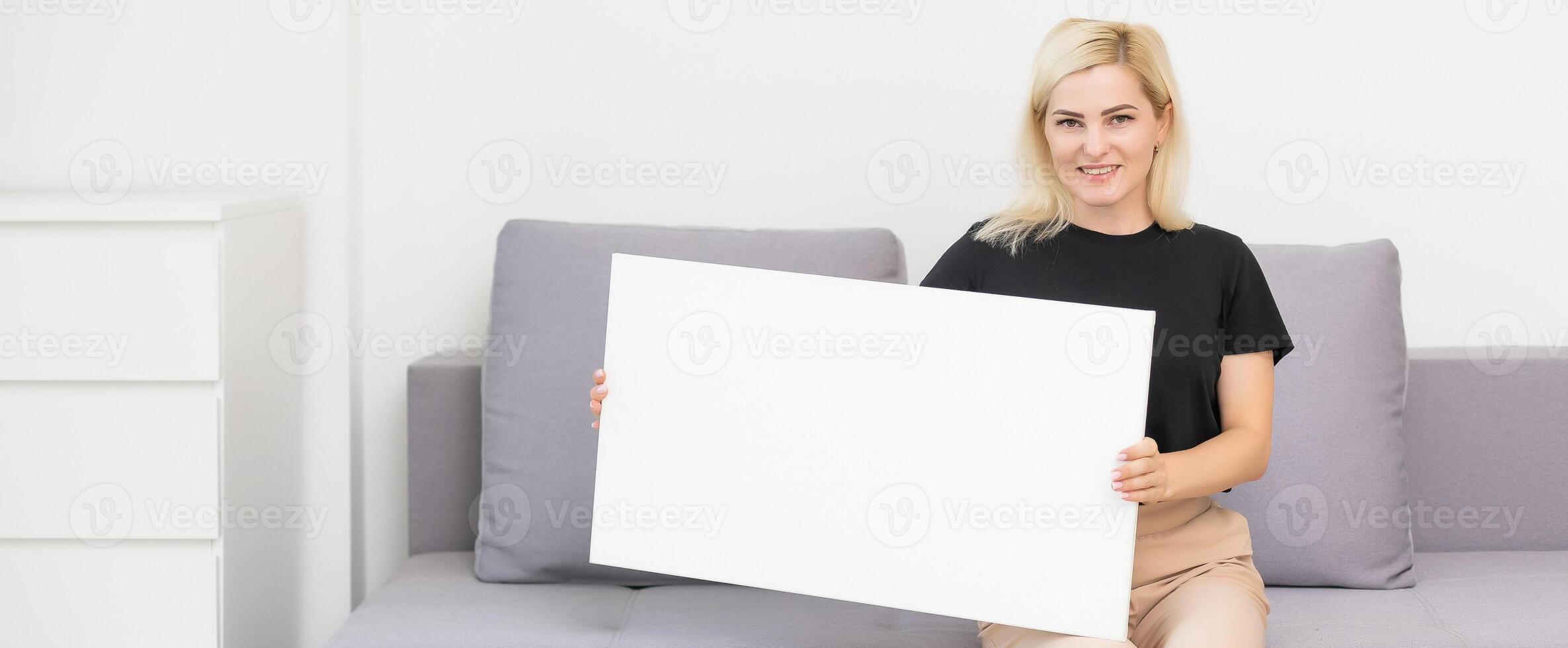 woman looking at the blank white canvas. Horizontal, mockup photo