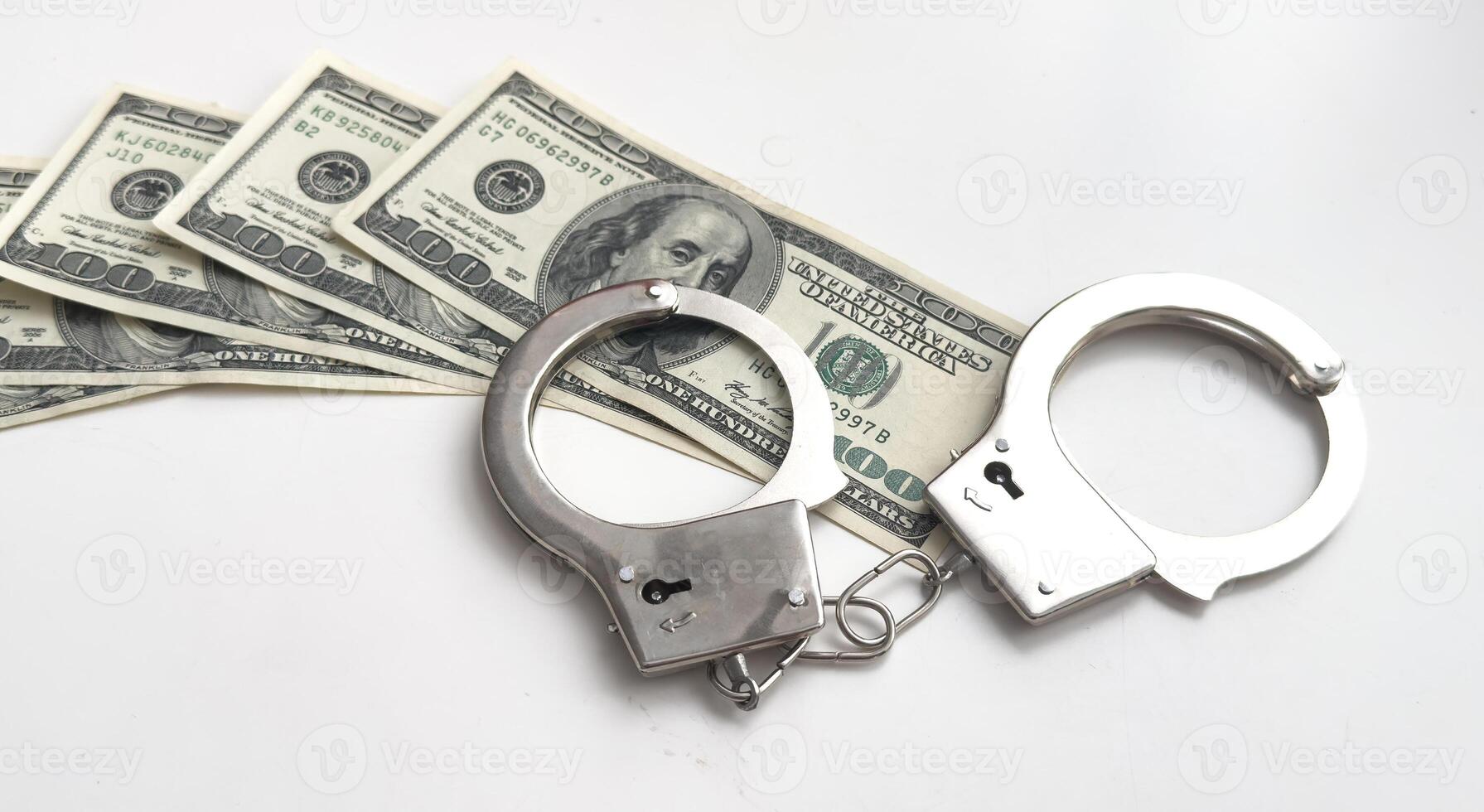 Dollars of hundred and fifty dollars lie on a floor and from above handcuffs for detention of the corrupt official on polichny are put. photo
