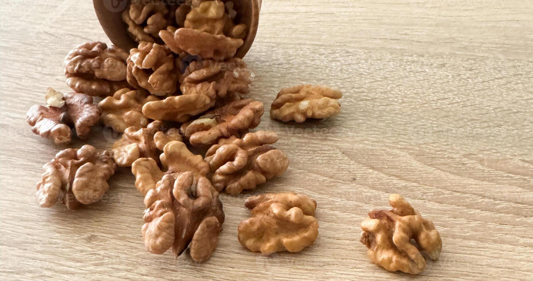 Whole walnuts and split on table. kernels of walnuts are dried and ready to eat. Soft focus. Blured picture. photo