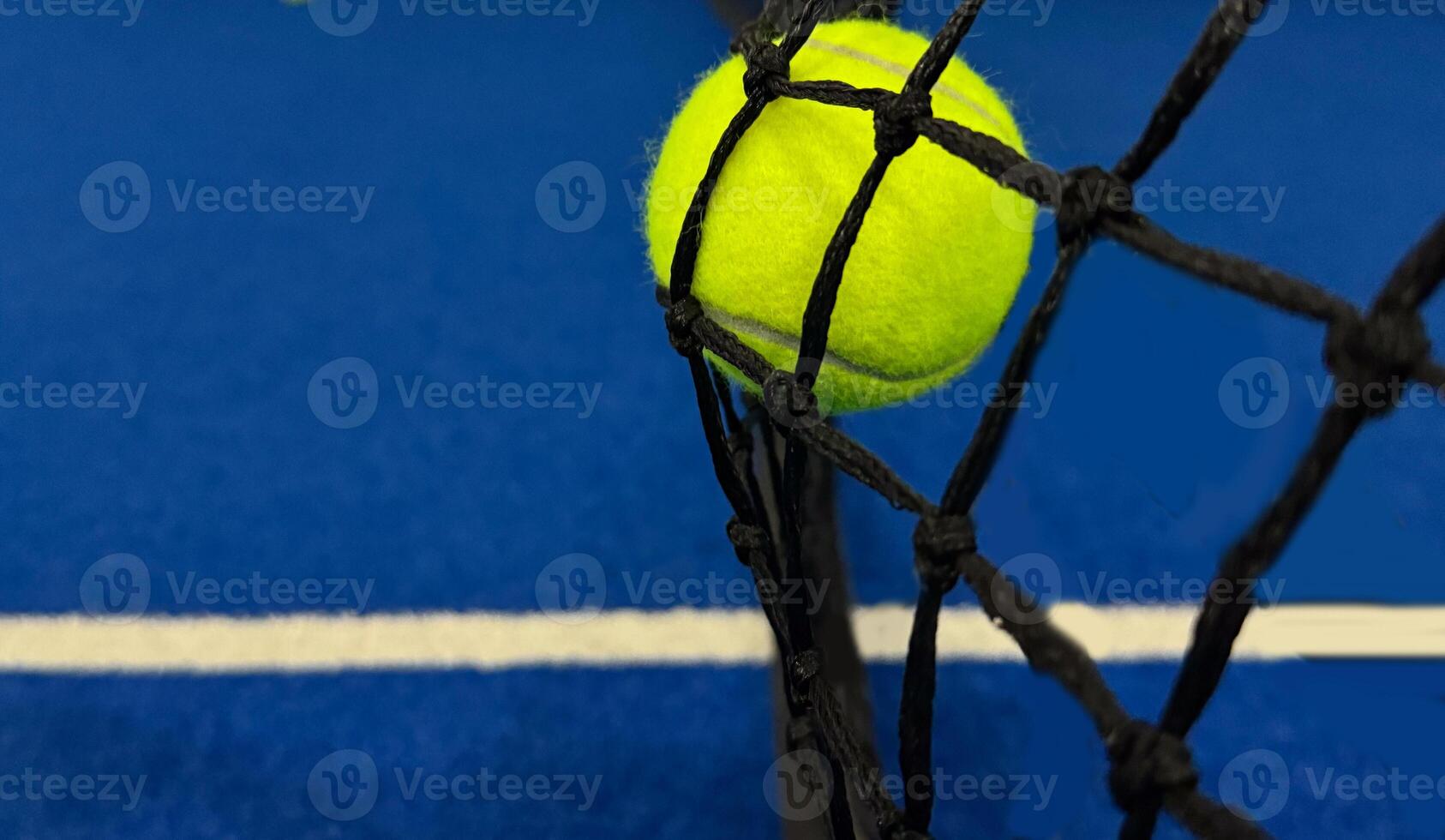 Tennis ball hitting on the net photo
