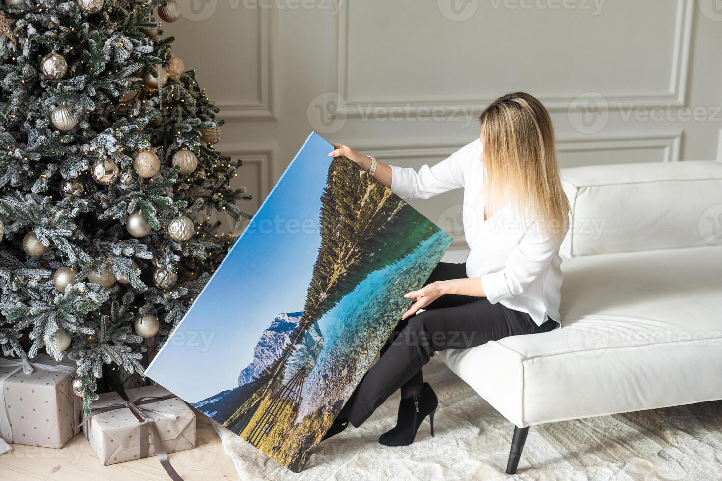 woman with photo canvas at christmas