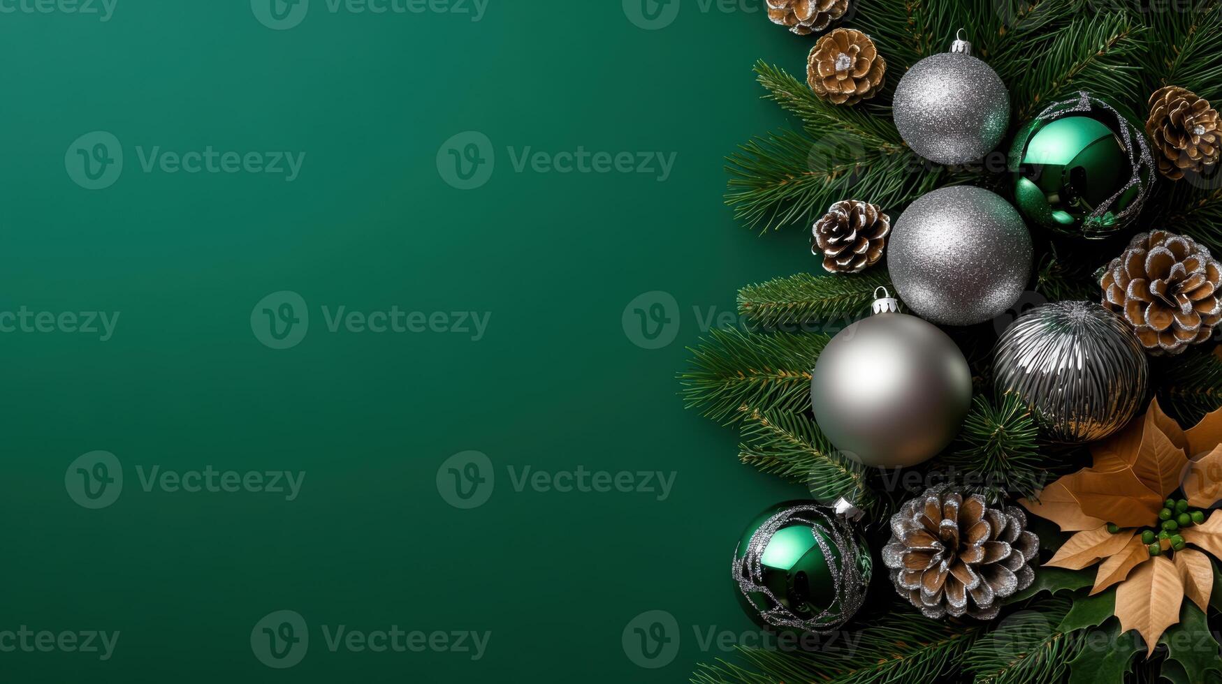 Christmas ornaments in silver and green with frosted pinecones and holiday greenery arranged on a rich green background. photo