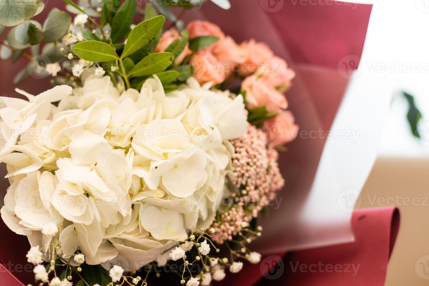 Colorful bouquet of different fresh flowers . Bunch of orchids, roses, freesia and eucalyptus leaves. Rustic flower background. Top view photo