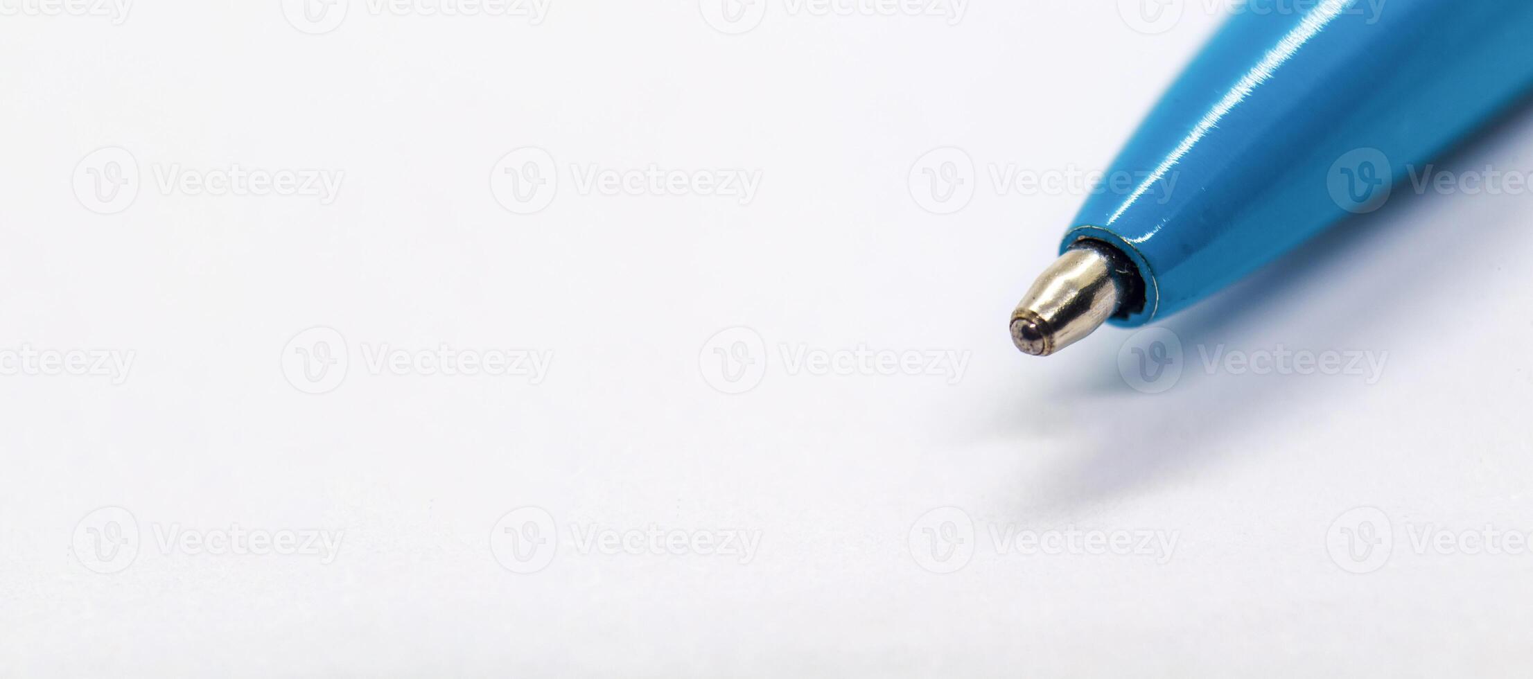 Top view of blue pen on wide white paper with customizable space for text or ideas. Copy space concept photo