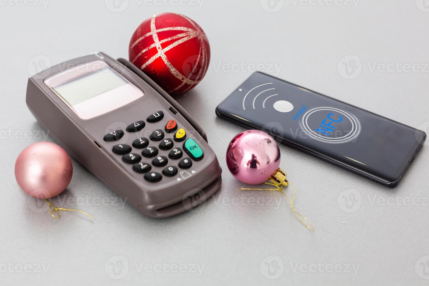 Customer using mobile phone to pay by NFC photo