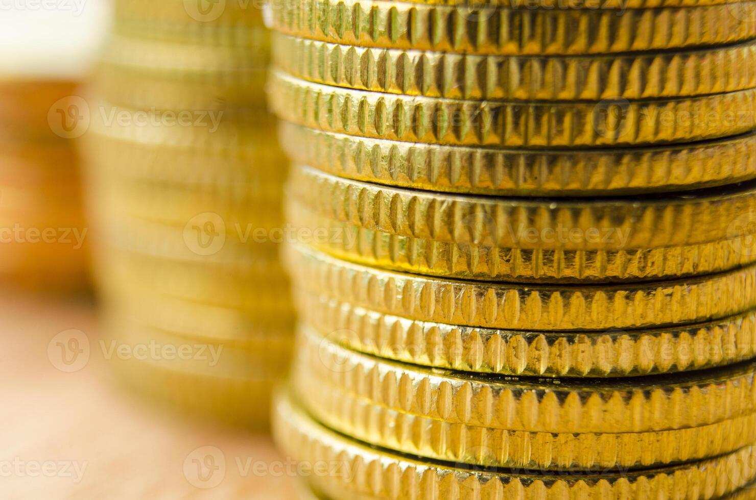 Side view of golden coins with customizable space for text. Business, banking and wealth concept photo