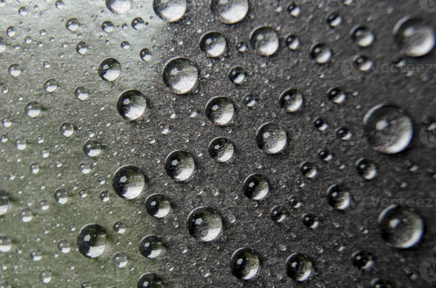 Focus on water droplets on dark cover suitable for wallpaper concept. photo