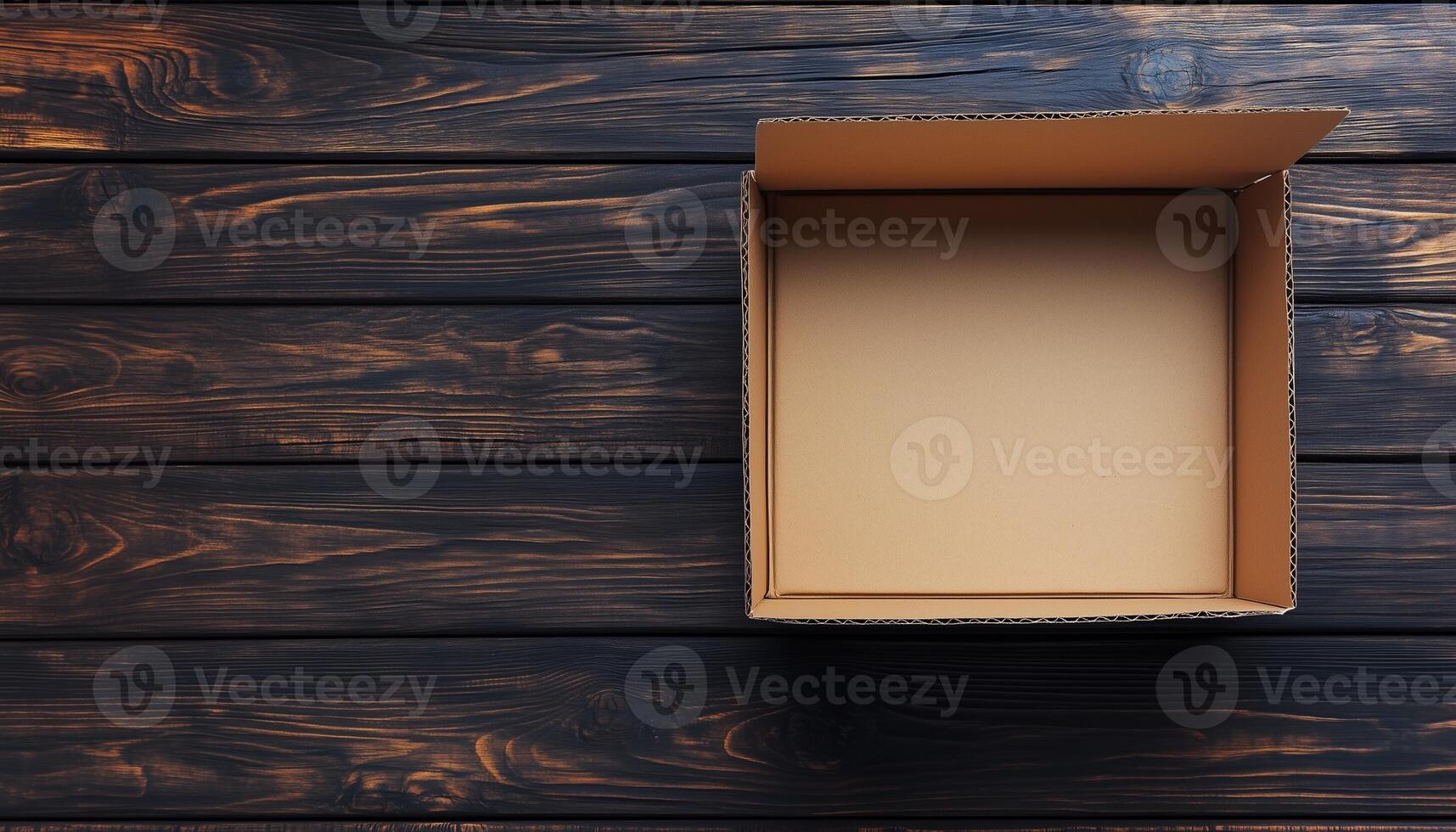 Flat lay brown empty open cardboard box carton package for packing copy space wooden background photo
