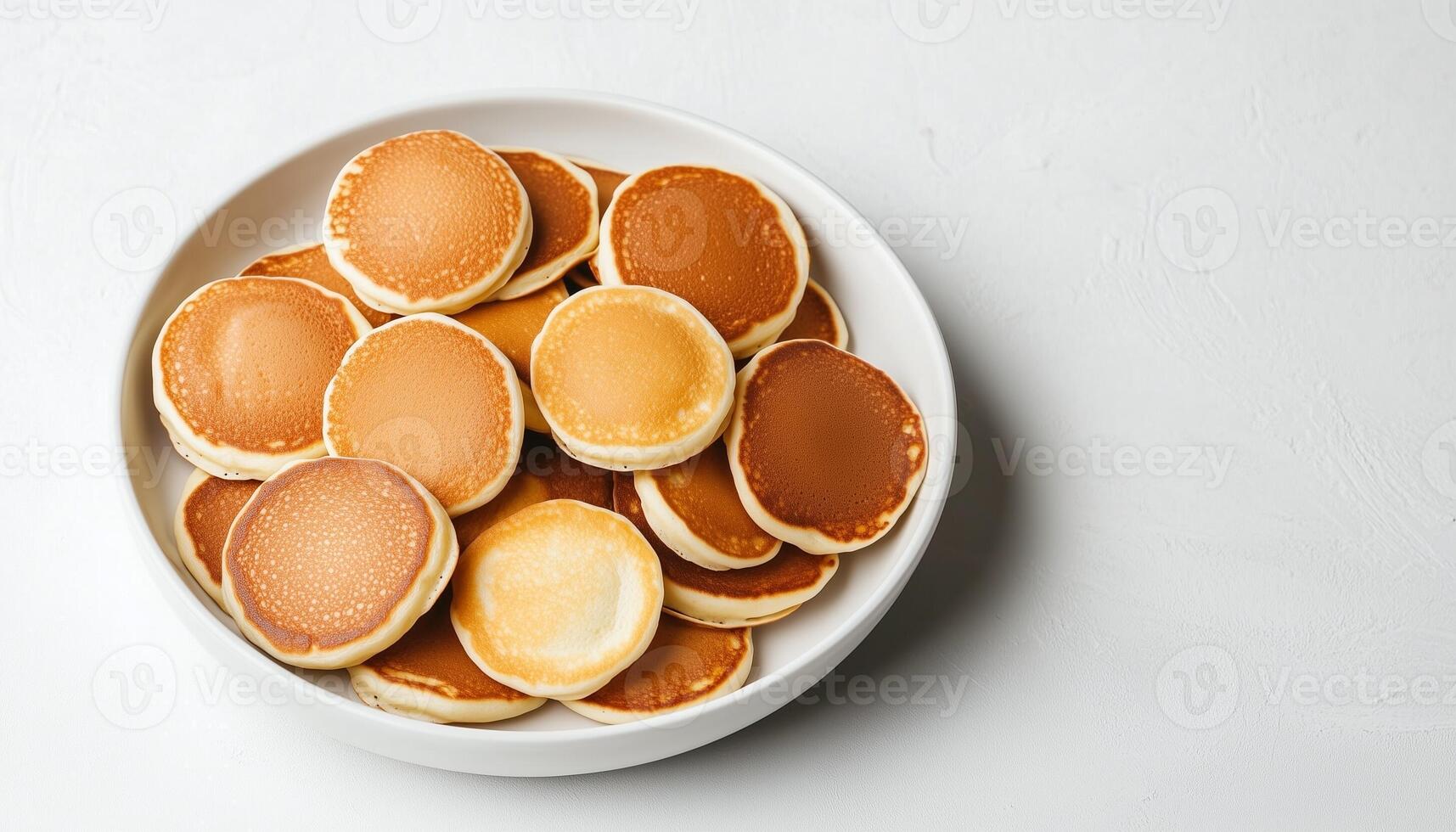 Mini pancakes simple food for breakfast on white plate, flat lay white background photo