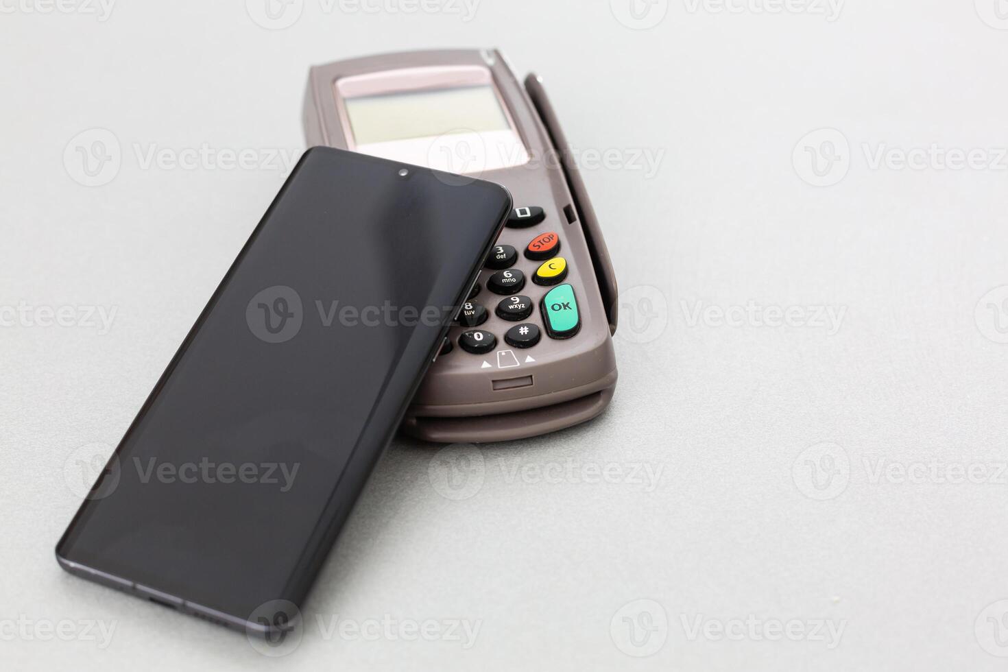 Customer using mobile phone to pay by NFC photo