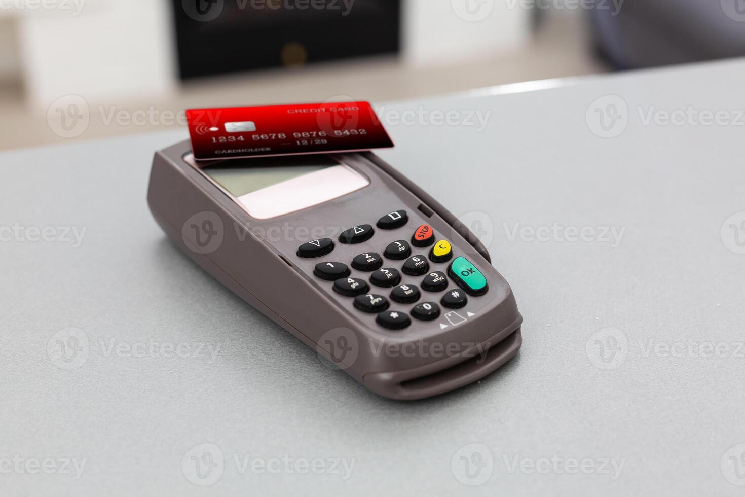 Online shopping concept. Close-up of a cash register next to a cart on a gray background, top view, copy space photo