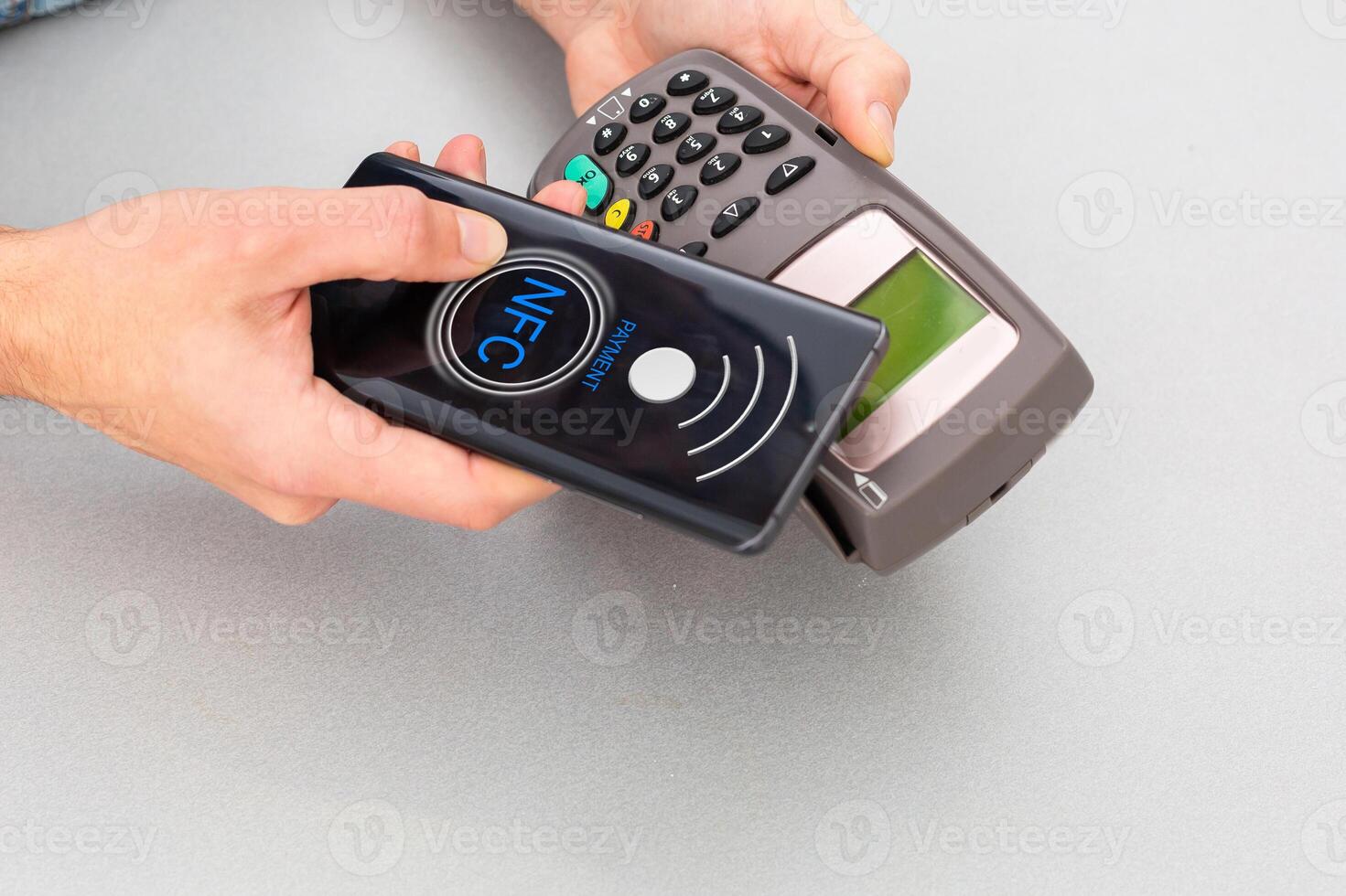 Customer using mobile phone to pay by NFC photo