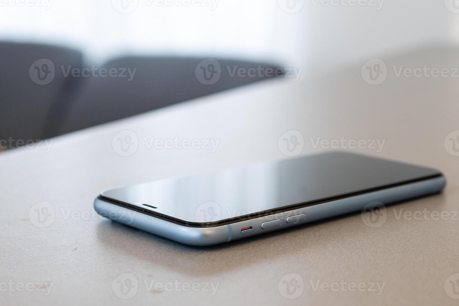 A single mobile phone on gray table photo