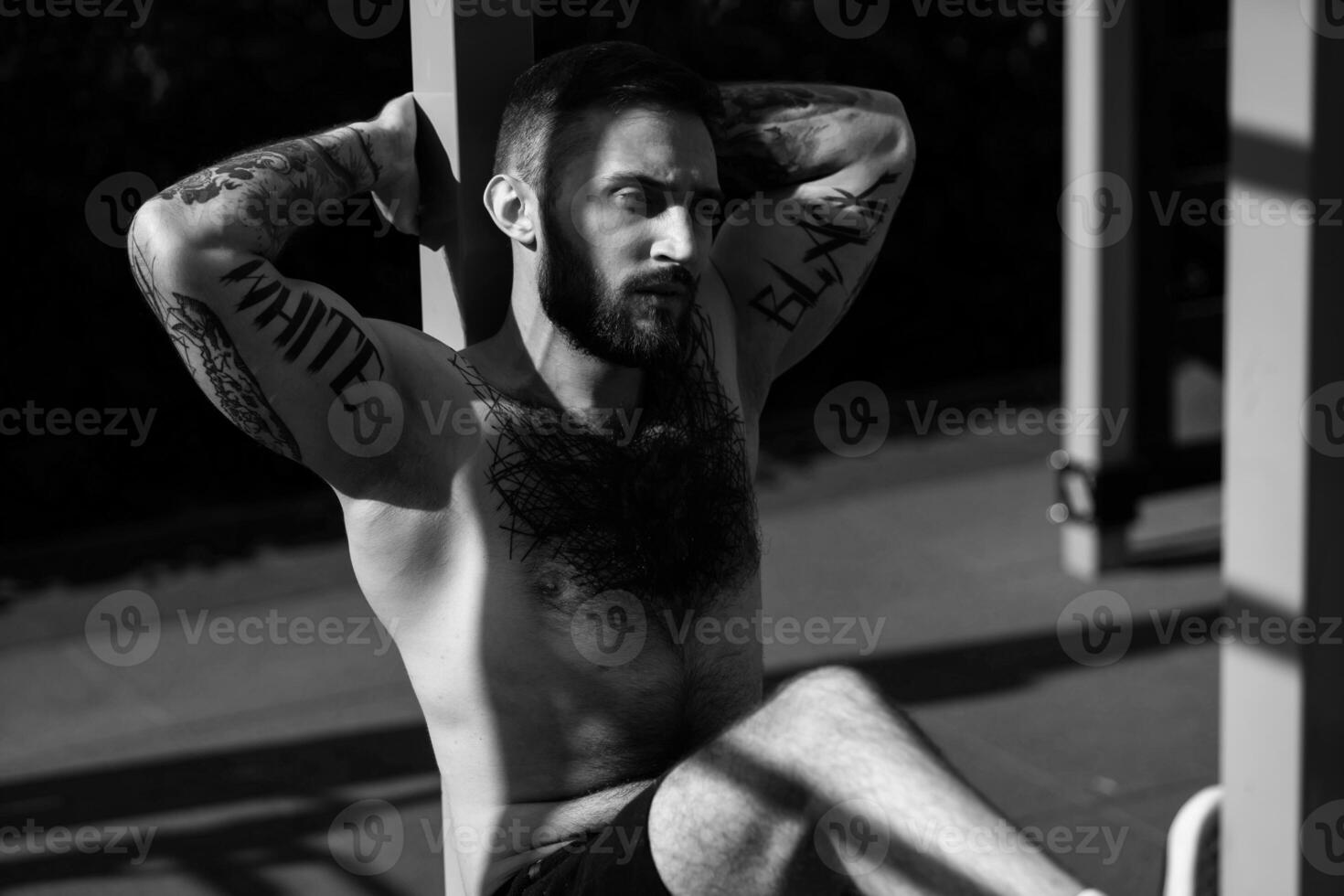 a man trains on the street with exercise machines photo