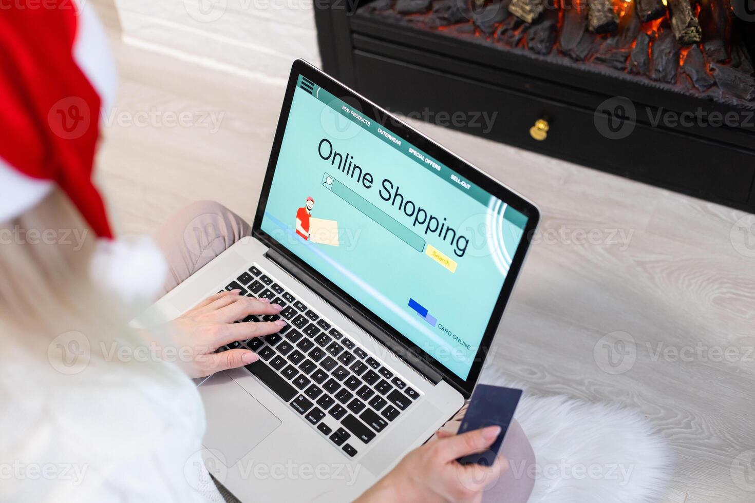 Christmas online shopping. Female buyer with laptop, copy space on screen. Woman buys presents, prepare to xmas eve, sitting among gifts boxes and packages. Winter holidays sales photo