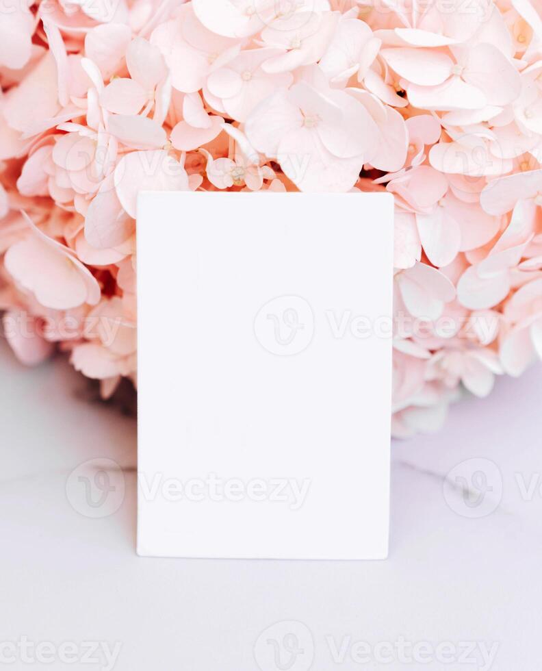 Mockup invitation or blank greeting card on a pink flower background photo