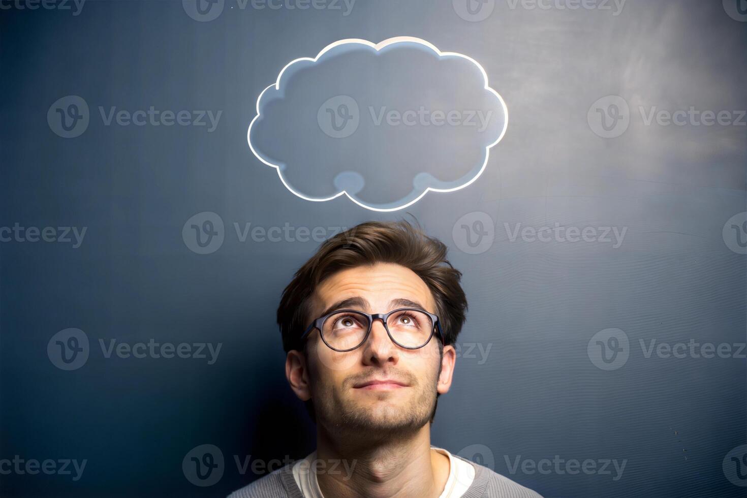 On the board next to the young man with glasses there is a cloud drawn for recording his thoughts. photo