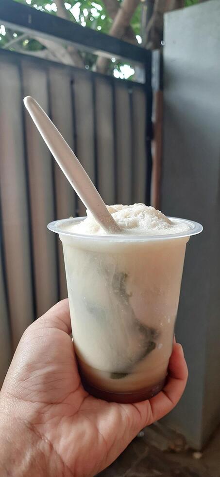 Es Cincau Hijau or Green Grass Jelly dessert. Indonesian traditional drink made from grass jelly, coconut milk and palm sugar syrup photo