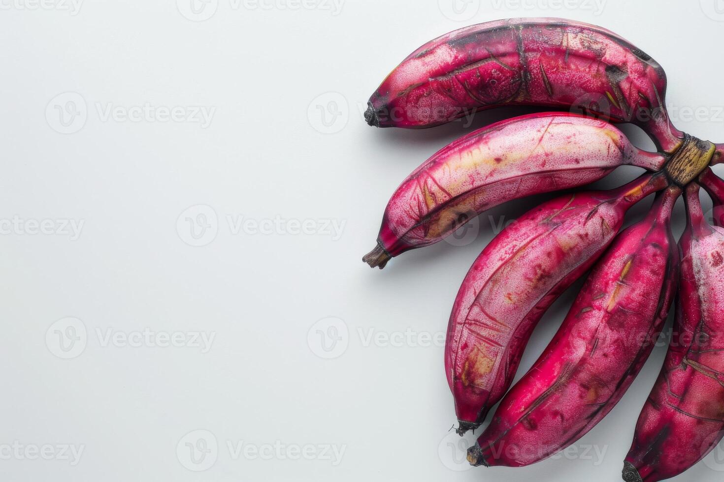 A bunch of purple bananas on a white surface photo