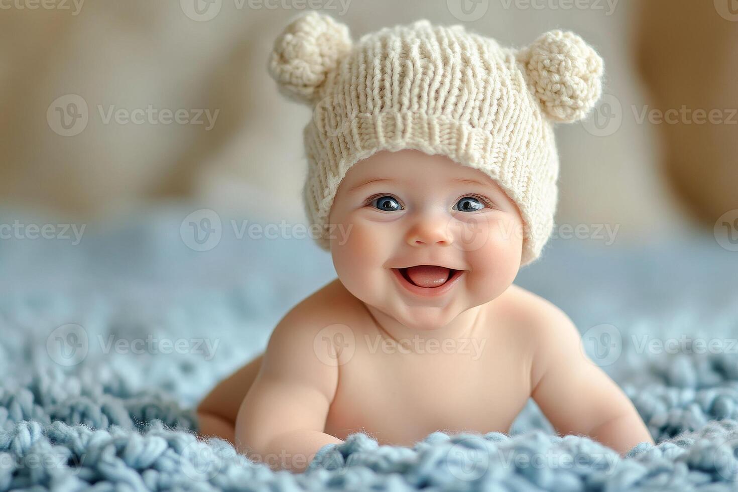 A baby wearing a knitted hat is smiling photo