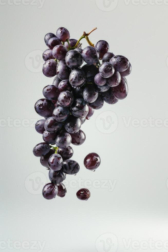A bunch of grapes is falling to the ground photo
