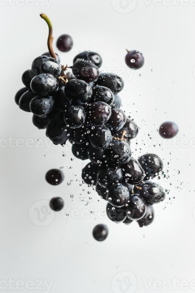 A bunch of grapes is being splashed with water photo