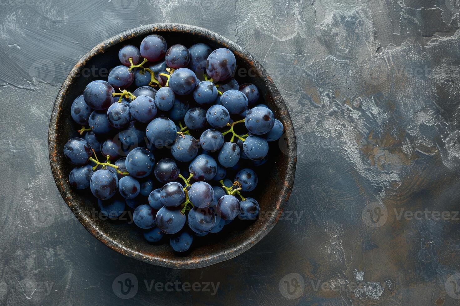 A bowl of grapes on a table photo