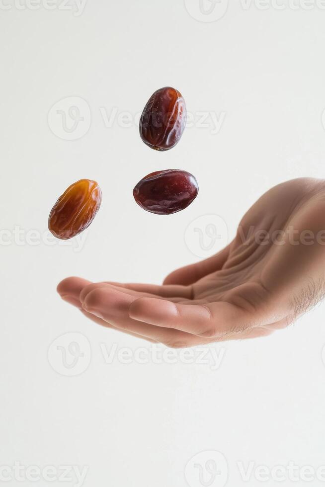 A hand holding a handful of dates photo