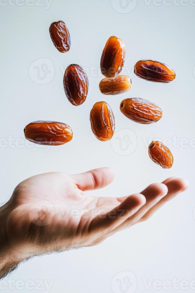 A hand holding a handful of dates photo