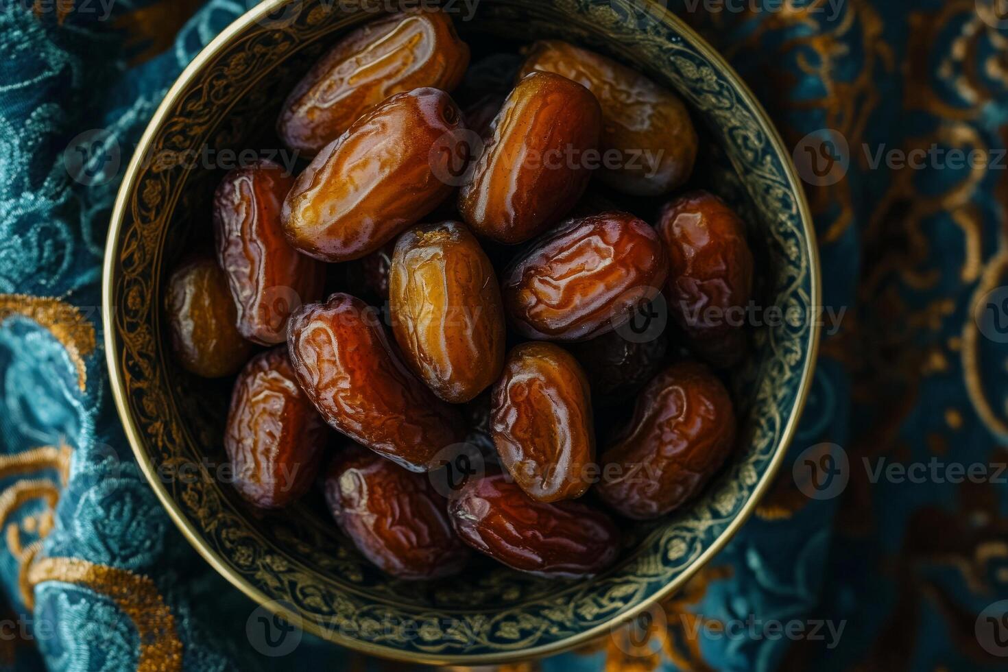 Dates in a bowl on a blue background photo