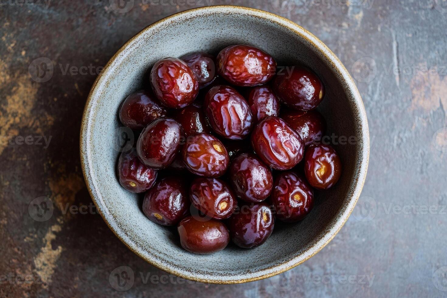 A bowl of dates on a table photo