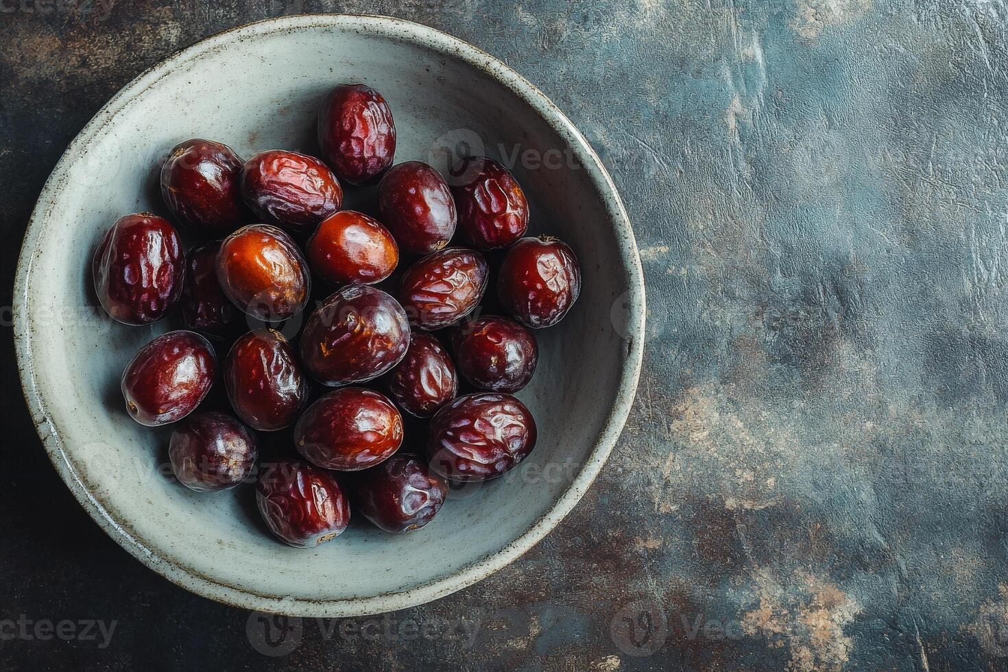 A bowl of dates on a table photo