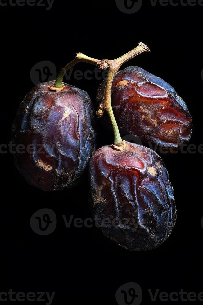 Three ripe dates on a black background photo