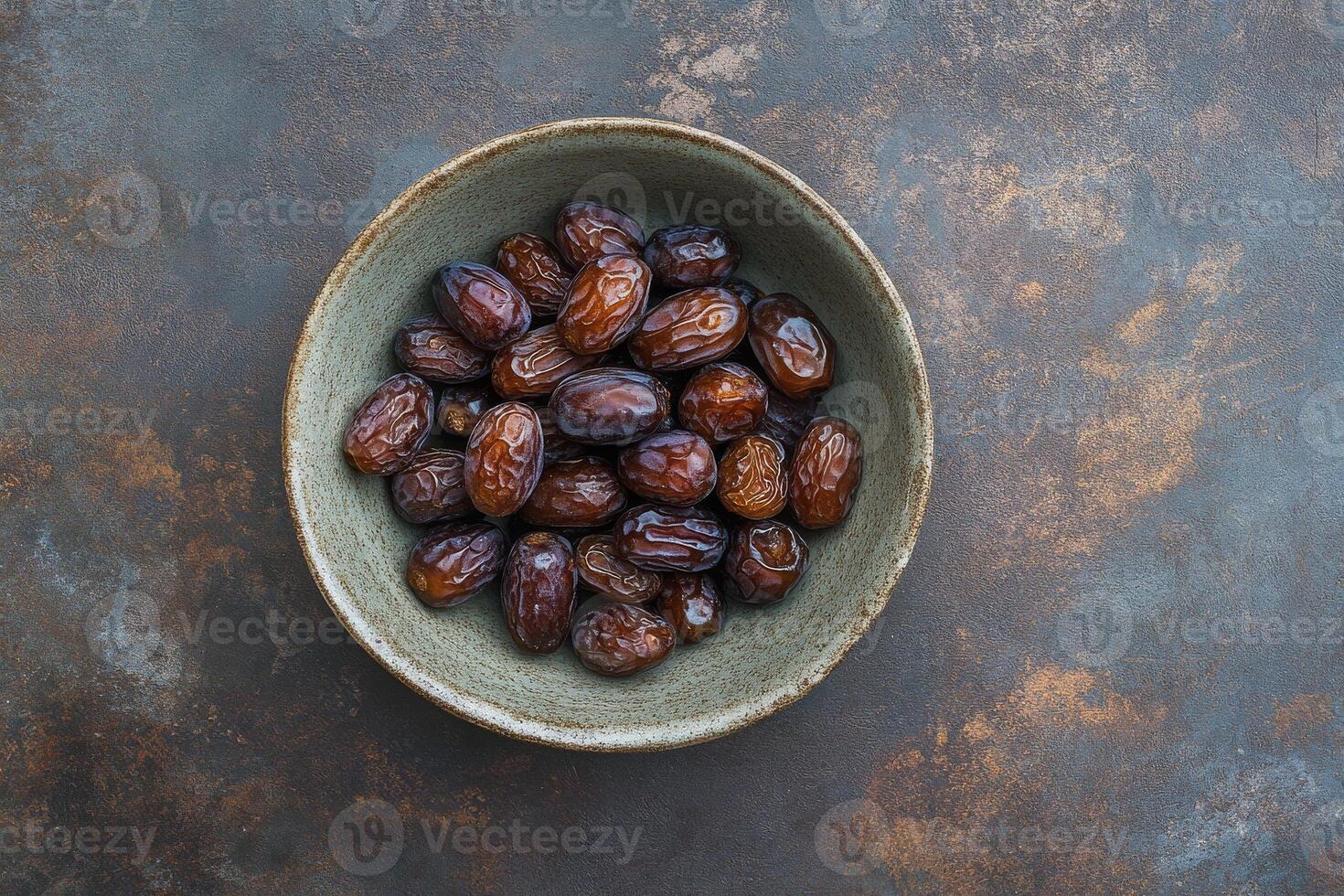 Dates in a bowl on a dark background photo