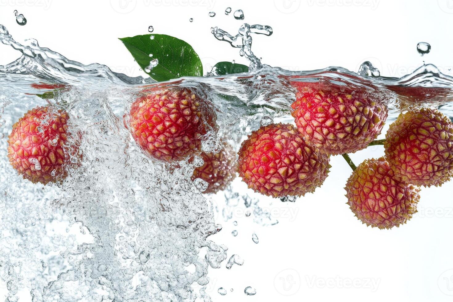 Fresh lychee fruit falling into water photo