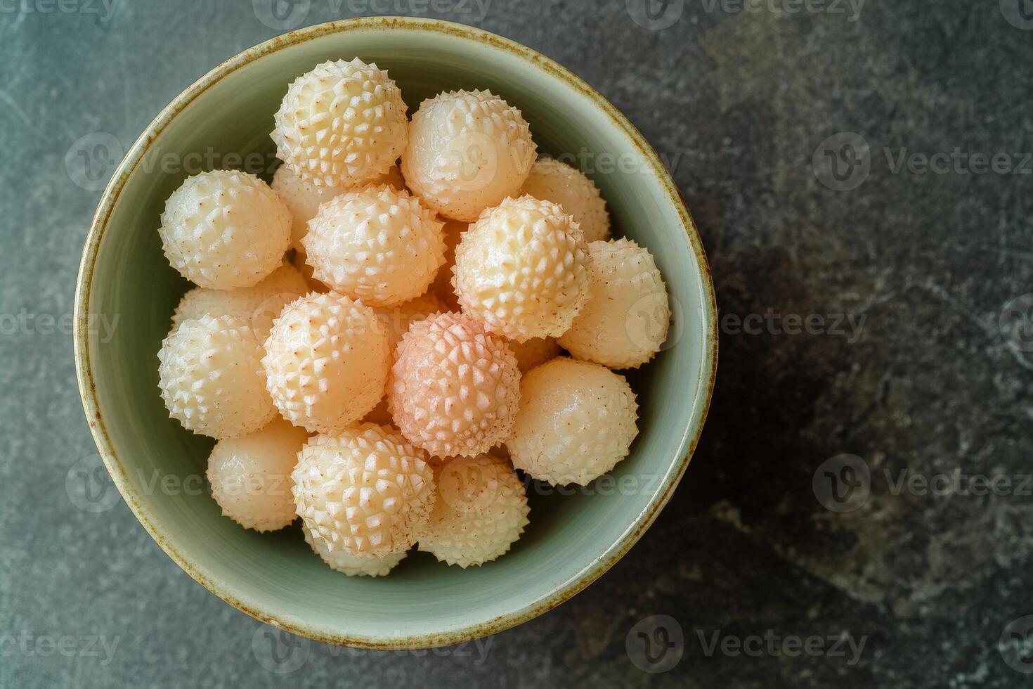 A bowl filled with white balls of fruit photo