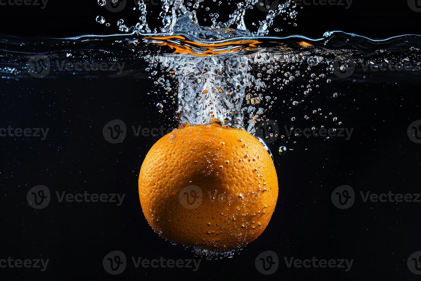 An orange is being dropped into water photo