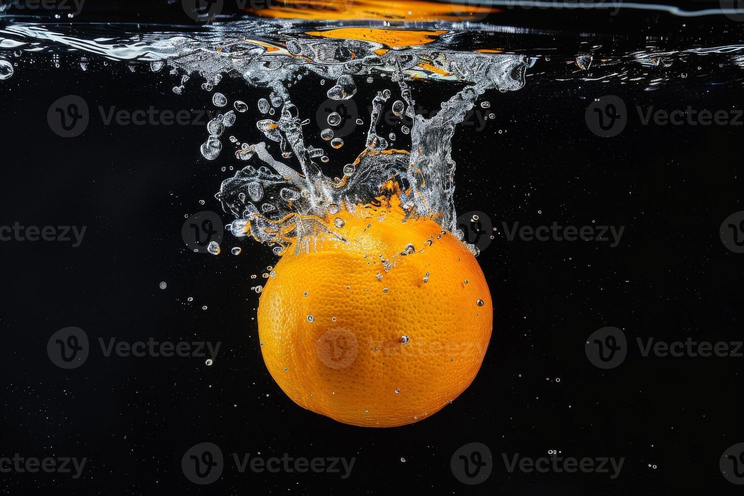 Orange falling into water on black background photo