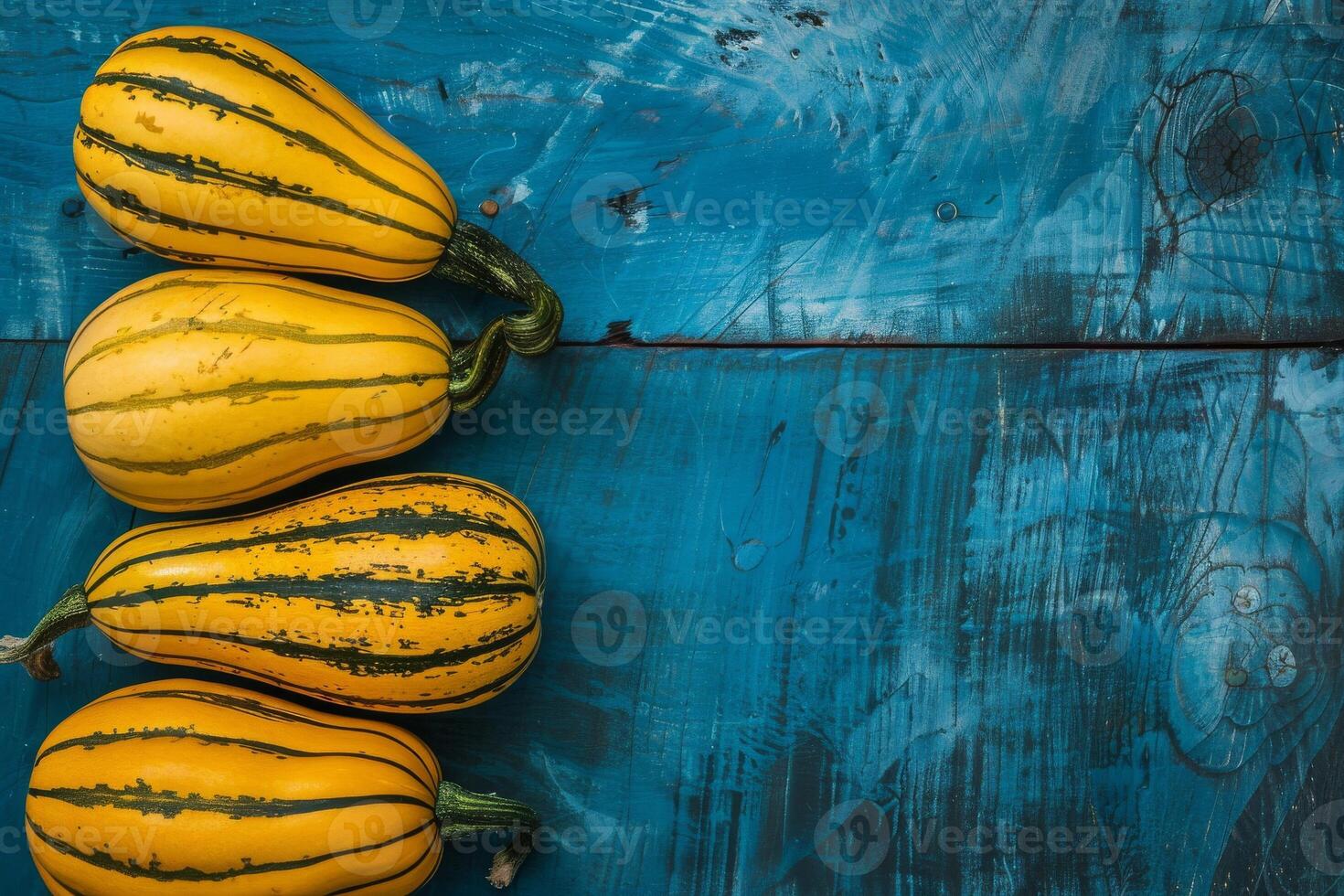 Three yellow squash on a blue wooden table photo