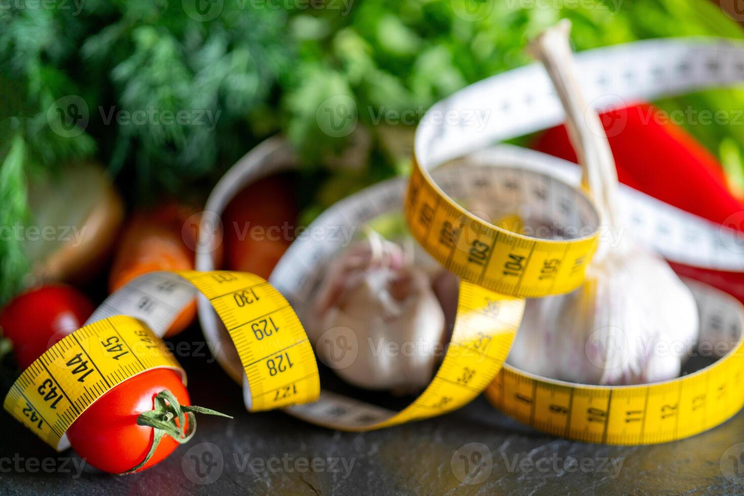 Measuring tape for measuring the circumference. Vegetables for diet cooking. photo