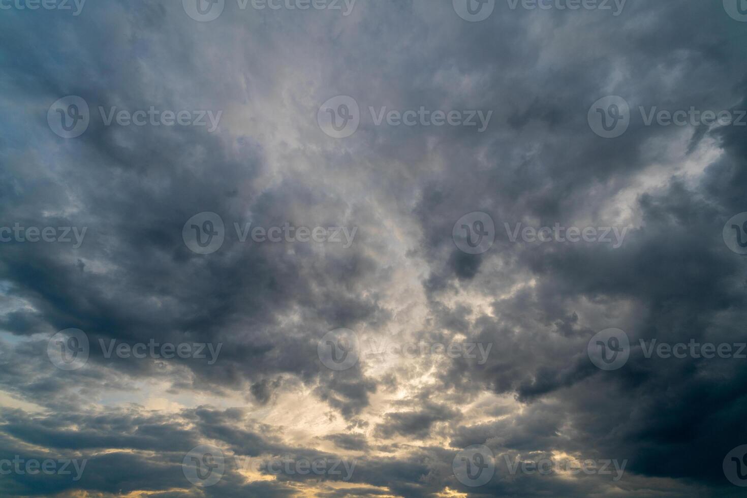 Dark gloomy clouds on a stormy sky. Natural atmospheric background. photo