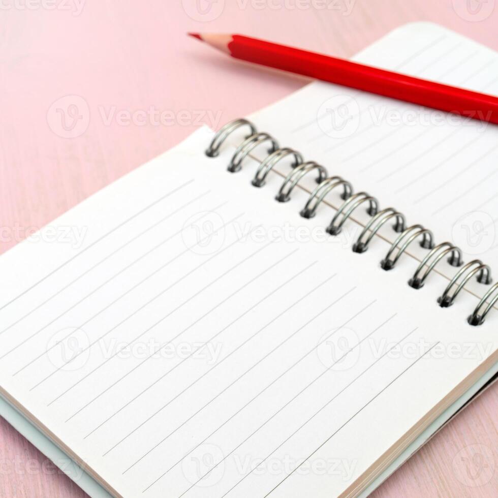 Red pencil and notebook for notes. photo