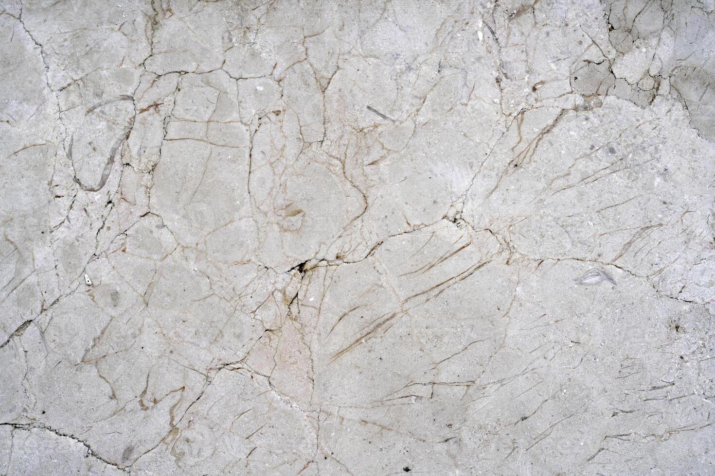 Cracks of gray marble. Wall of house. Construction industry. photo