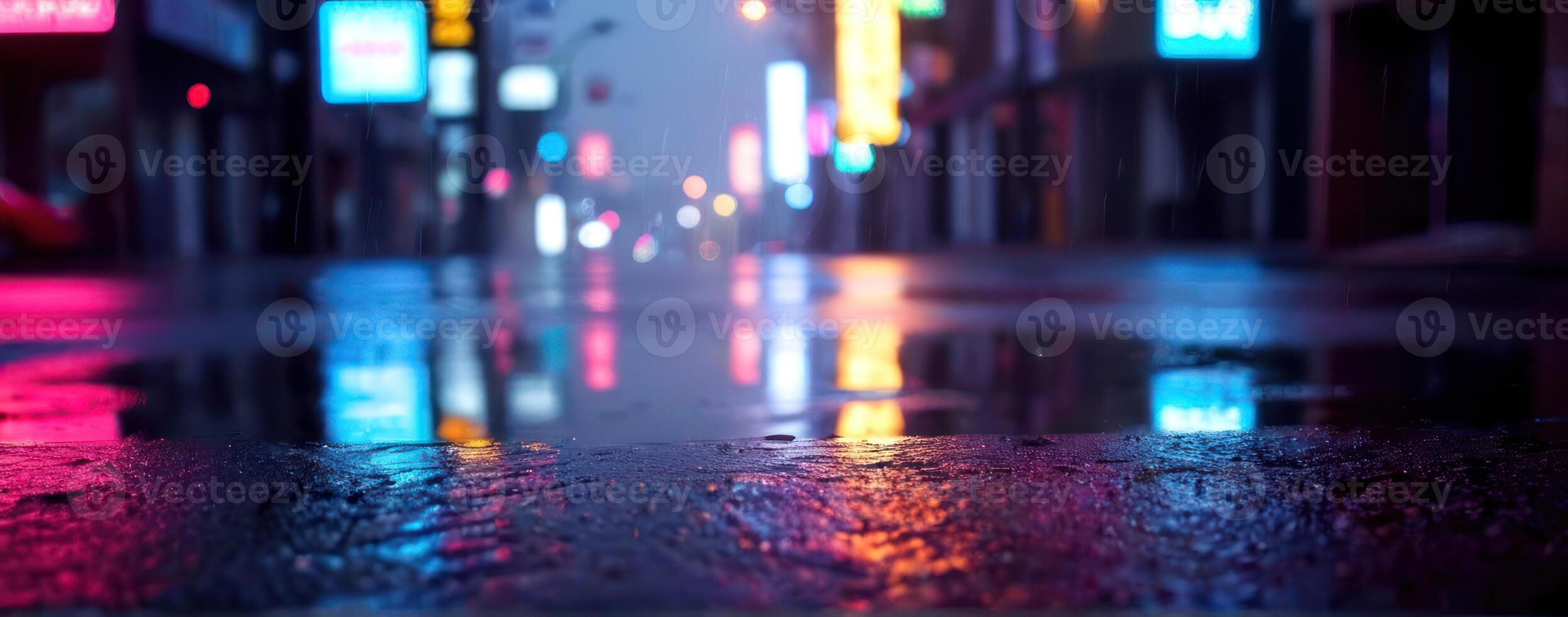 An image of a wet street at night with neon lights photo